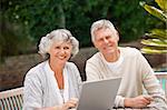 Retired couple working on their laptop