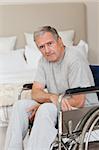 Thoughtful senior man in his wheelchair  at home