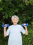 Mature woman doing her exercises in the garden