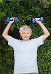 Mature woman doing her exercises in the garden