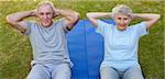 Retired couple doing their streches in the garden