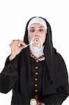 Nun blowing out a huge bubble through a plastic wand