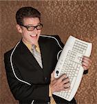 Caucasian business man playing guitar with a computer keyboard