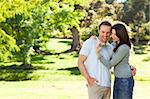 Radiant couple hugging in the park