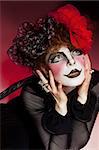 Woman mime with theatrical makeup. Studio shot.