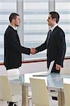 two young businessman handshake on business meeting at modern office and representing success