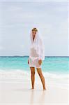 Bride on a coastline at tropical beach