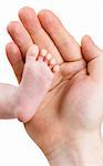 Small leg of the newborn baby girl in the big hand of the father, isolated on a white background