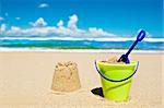 Toy bucket and shovel on the beach on a sunny day