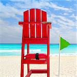 Baywatch red beach seat green wind flag in tropical caribbean sea
