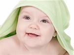 Cute smiling baby with a green towel on a white
