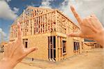 Female Hands Framing New Home Frame on Construction Site.