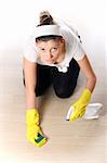 A picture of a young woman cleaning the floor over light background