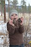 Warmly dressed boy playing outside in the snow