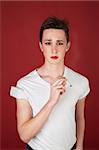 Caucasian tough teen in t-shirt smoking a cigarette