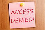 Access denied word  post it on wooden wall