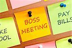 Boss meeting post it on wooden wall