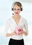 Young businesswoman with headset holding piggy bank