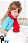 Sick little beautiful girl with red scarf in the bed