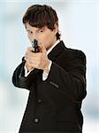 Businessman aiming with handgun.