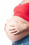 Pregnant woman holding her belly with hands over white background