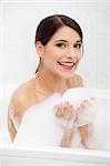 Beautiful young caucasian woman taking a bath.