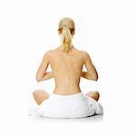 Young beautiful nude blond woman meditating , isolated on white