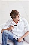 A young man with a cup of coffee on the couch