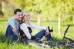 A couple with bikes in autumn park