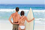 Couple with their surfboard