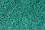 Close-up of a green cleaning sponge surface as a backdrop