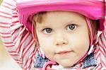 Portrait of little girl with pink bicycle helmet