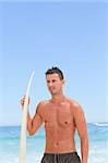Man posing with his surfboard