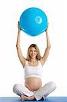 Pregnant woman practicing yoga with ball isolated on white