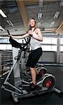 woman is training on cardio machine  at gym