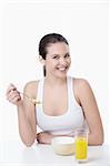 Young attractive girl breakfast corn flakes on a white background