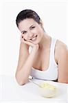 Attractive girl at breakfast on a white background