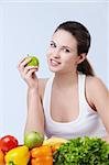 Young attractive girl with fruits and vegetables on white background