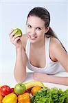 Attractive girl with fruits and vegetables on white background