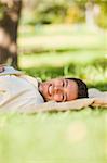 Man lying in the park with his book