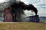 Old retro steam train stopped at the small station