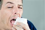 Close-up of a man sneezing.