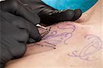 closup of hands of a tattoo artist at work