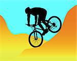silhouette of a mountain biker riding in the mountains against the blue sky