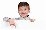 Smiling little boy holding empty white board