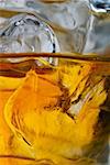 Close up photo of a glass of whiskey on the rocks