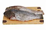 Ready for cooking - two scaled dusky  grouper fish (locus) on bamboo cutting board isolated on white background