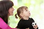 Portrait of a 2 year old girl with young mum