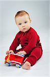 baby boy playing his toy car in studio