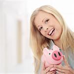 Businesswoman holding piggy bank.